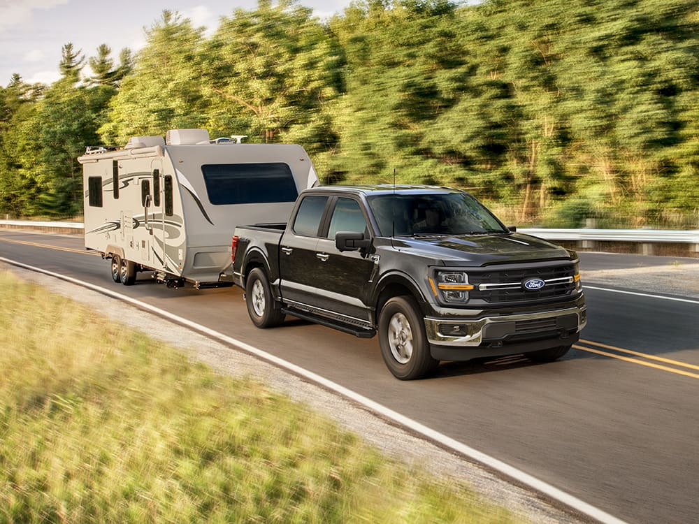 2026 Ford F-150 towing a camper.